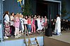 Kör med kvinnor iklädda färgglada kläder sjunger.